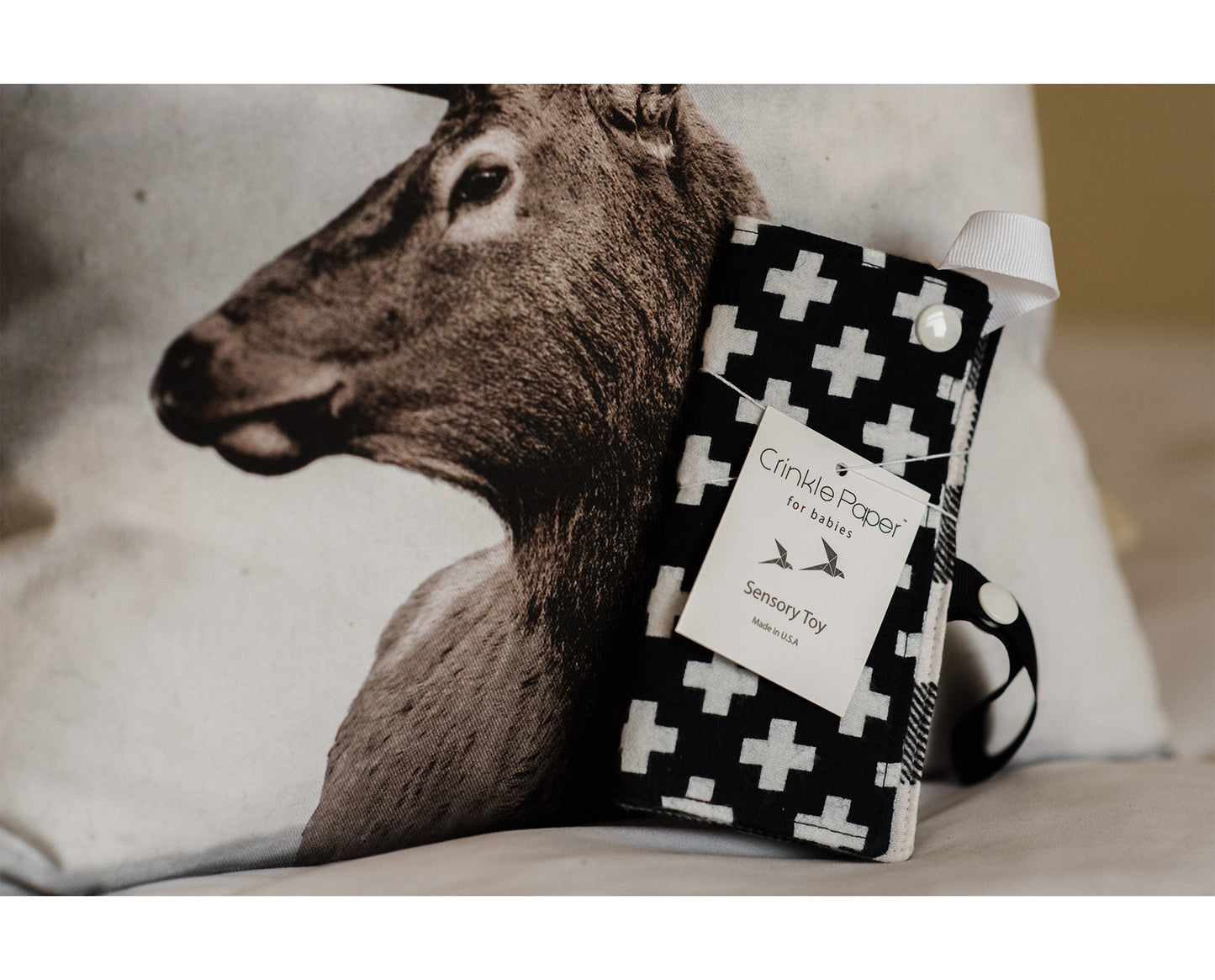 soft fabric sensory toy for infants with sewn in crinkle material for that fun 'crinkle' sound and strap for easy access